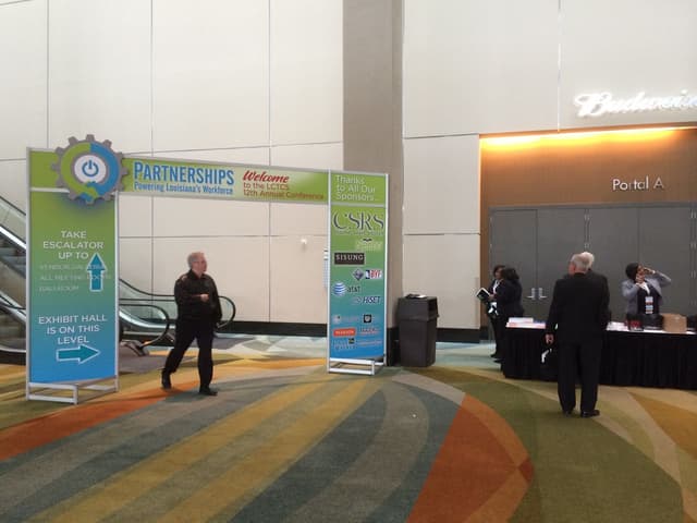 Conference entrance with custom sponsor signage and patterned event carpet